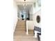Welcoming entryway features modern lighting, stairs and stylish decor at 8203 Bluestar Cir, Orlando, FL 32819