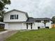 Inviting two-story home with a manicured lawn and a white exterior at 8203 Bluestar Cir, Orlando, FL 32819