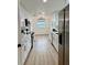 Updated kitchen features white cabinets, stainless steel appliances, and modern lighting at 8203 Bluestar Cir, Orlando, FL 32819