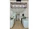 Renovated kitchen boasts white cabinets, stainless steel appliances, and modern lighting at 8203 Bluestar Cir, Orlando, FL 32819