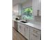 Kitchen features white cabinets, granite countertops and modern faucet at 8203 Bluestar Cir, Orlando, FL 32819