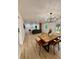 Open-concept living room and dining area with wood floors and modern chandelier at 8203 Bluestar Cir, Orlando, FL 32819