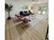 Bright living room featuring wood floors, neutral decor, and comfortable seating at 8203 Bluestar Cir, Orlando, FL 32819