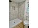 Modern shower featuring stylish grey tiling with a built-in niche and sleek fixtures at 8203 Bluestar Cir, Orlando, FL 32819