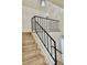 Staircase with modern black railing and wood stairs at 8203 Bluestar Cir, Orlando, FL 32819