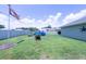 Spacious backyard showcasing a well-maintained lawn, lush landscaping, and an above ground swimming pool at 8489 Se 158Th Pl, Summerfield, FL 34491