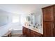 Bright bathroom featuring double vanity, soaking tub, and separate shower area at 8489 Se 158Th Pl, Summerfield, FL 34491