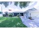 A charming single-story home with a lush green lawn, screen enclosed porch and beautiful landscaping at 8489 Se 158Th Pl, Summerfield, FL 34491