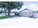 Charming single-story home featuring an attached two-car garage, a wide driveway and a lush front lawn at 8489 Se 158Th Pl, Summerfield, FL 34491