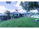 Well-maintained lawn and vibrant shrubbery decorate this single-story home with a screened-in porch at 8489 Se 158Th Pl, Summerfield, FL 34491