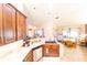 Kitchen sink with granite countertops and a view of the dining and living areas beyond at 8489 Se 158Th Pl, Summerfield, FL 34491