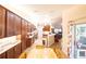 Spacious kitchen with dark wood cabinets, granite countertops, stainless steel appliances and an eat-in dining space at 8489 Se 158Th Pl, Summerfield, FL 34491