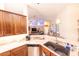 Kitchen counter featuring stone countertops, cabinets, stainless steel dishwasher, sink, and pendant lights at 8489 Se 158Th Pl, Summerfield, FL 34491