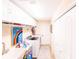 Bright laundry room with a washer, dryer, storage cabinets, and a utility sink at 8489 Se 158Th Pl, Summerfield, FL 34491