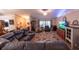 Cozy living room featuring tile floors, a large sofa and a big screen TV at 8489 Se 158Th Pl, Summerfield, FL 34491