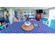 A delightful, screened-in patio features colorful decor, comfy seating, and an American flag themed table at 8489 Se 158Th Pl, Summerfield, FL 34491