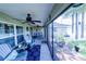 Cozy screened porch with comfortable seating, ceiling fans, and a view of the outdoors at 8489 Se 158Th Pl, Summerfield, FL 34491