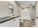 Clean bathroom with a vanity, large mirror, and white shower and toilet at 892 Se 124Th Ave, Webster, FL 33597
