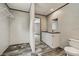 Bathroom featuring an ample closet area and a combined vanity with sink and toilet at 892 Se 124Th Ave, Webster, FL 33597