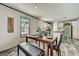 Bright dining area with a wooden table, stylish bench seating, and a view of the kitchen at 892 Se 124Th Ave, Webster, FL 33597