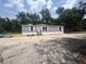 A single-story home with grey siding and a small entry staircase at 892 Se 124Th Ave, Webster, FL 33597