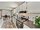 Modern kitchen with black countertops, white cabinetry, and stainless steel appliances at 892 Se 124Th Ave, Webster, FL 33597