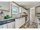 Well-lit kitchen features stainless steel appliances, white cabinets, and modern countertops at 892 Se 124Th Ave, Webster, FL 33597