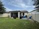 Spacious backyard with covered patio, grill, and ample play space at 9219 Chandler Dr, Groveland, FL 34736