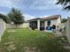 Spacious backyard with covered patio, grill, and ample play space at 9219 Chandler Dr, Groveland, FL 34736