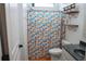 Bright bathroom features a shower with a fun, patterned curtain and stylish decor, offering a fresh and inviting space at 9219 Chandler Dr, Groveland, FL 34736