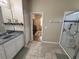 Bathroom featuring a vanity, tile flooring, and a glass enclosed shower at 9219 Chandler Dr, Groveland, FL 34736