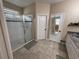 Bright bathroom featuring a glass shower with tile surround, neutral paint and flooring at 9219 Chandler Dr, Groveland, FL 34736