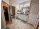Bright bathroom with double sink vanity, large mirror, and tile flooring at 9219 Chandler Dr, Groveland, FL 34736