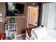 Cozy bedroom featuring a TV, bookshelf, and comfortable bedding, creating a relaxing and inviting retreat at 9219 Chandler Dr, Groveland, FL 34736