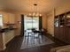 Inviting dining area with table and chairs, set on a patterned rug, next to a sliding glass door, and a view of the backyard at 9219 Chandler Dr, Groveland, FL 34736