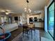Open-concept dining area features stylish light fixture and seamlessly flows into the kitchen, perfect for modern living at 9219 Chandler Dr, Groveland, FL 34736