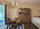 Cozy dining area featuring modern lighting and a display cabinet at 9219 Chandler Dr, Groveland, FL 34736