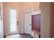 Welcoming foyer featuring wood-look tile flooring, a decorative bench and a paneled accent wall at 9219 Chandler Dr, Groveland, FL 34736