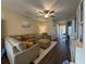 Spacious living room featuring comfortable seating and wood-look flooring at 9219 Chandler Dr, Groveland, FL 34736