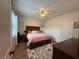 Comfortable main bedroom with ceiling fan, wood-look floors, and abundant natural light, creating a relaxing and inviting retreat at 9219 Chandler Dr, Groveland, FL 34736