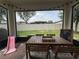 Covered patio with brick pavers, outdoor furniture, and backyard views at 9219 Chandler Dr, Groveland, FL 34736