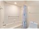Bathroom featuring shower and tub combination with accessibility bars at 9499 Se 174Th Loop, Summerfield, FL 34491