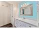 Bright bathroom with sink vanity, large mirror and wood flooring at 9499 Se 174Th Loop, Summerfield, FL 34491