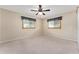Neutral bedroom with carpet, ceiling fan, and two windows at 9499 Se 174Th Loop, Summerfield, FL 34491
