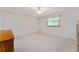 Carpeted bedroom with natural light from a window and a ceiling fan at 9499 Se 174Th Loop, Summerfield, FL 34491