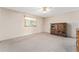 Neutral bedroom features a ceiling fan, window, and wood display cabinet at 9499 Se 174Th Loop, Summerfield, FL 34491