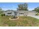 Inviting single-story home with a well-kept lawn, landscaped flower beds, and a two-car garage at 9499 Se 174Th Loop, Summerfield, FL 34491