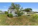 Charming home exterior with well-maintained lawn and colorful flowering trees at 9499 Se 174Th Loop, Summerfield, FL 34491