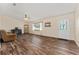 Cozy living room with laminate flooring, and a beautiful front door at 9499 Se 174Th Loop, Summerfield, FL 34491