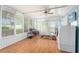 Bright sunroom with ceiling fan and lots of windows, plus washer and dryer at 9499 Se 174Th Loop, Summerfield, FL 34491